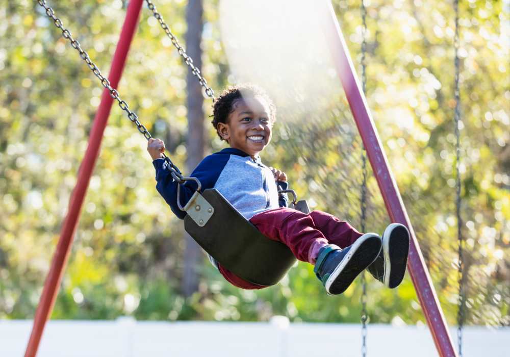 Resident kid at community playground near Creekwood Apartments in Gainesville, Florida