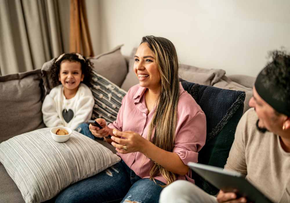 A happy family having good time in their comfy living room at Wayne Densch Center in Orlando, Florida
