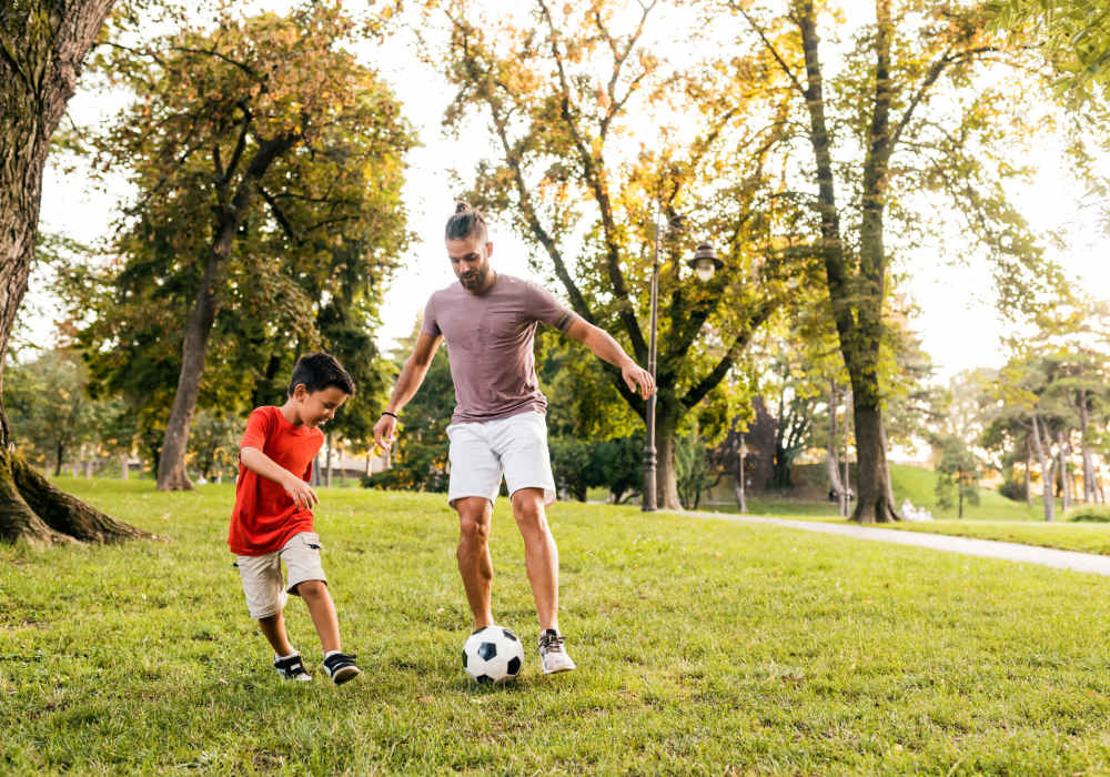 Resident and his son playing football in a part near The Element At 464 in Daytona Beach, Florida 