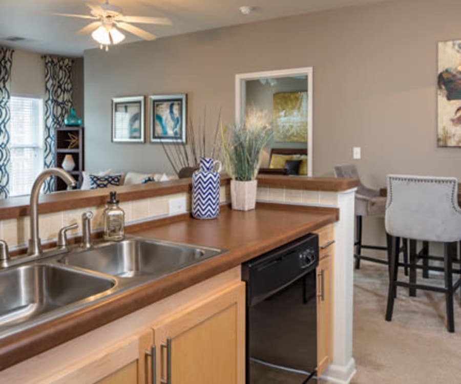 Model home's living area with hardwood floors and modern furnishings at The Fairways Apartment Homes in Lee's Summit, Missouri