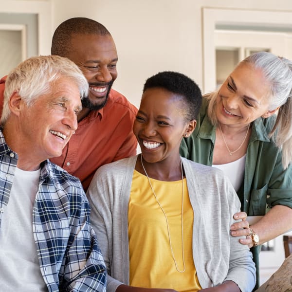 4 residents smiling together at The Wildwood Senior Living in Joplin, Missouri