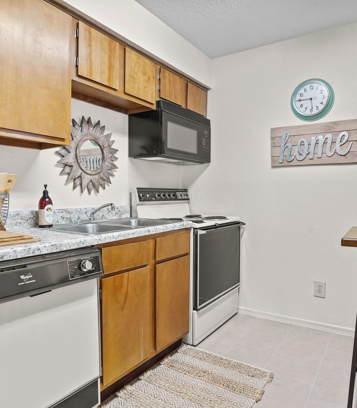 The Kitchen with granite countertops at Creekwood Apartments in Tulsa, Oklahoma