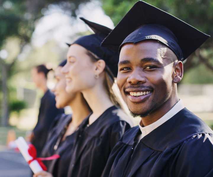 Smiling college student during convocation on campus near Kirman Garden in Reno, Nevada 