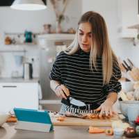 Resident woman chopping vegetables at Axis on Lexington in Louisville, Kentucky