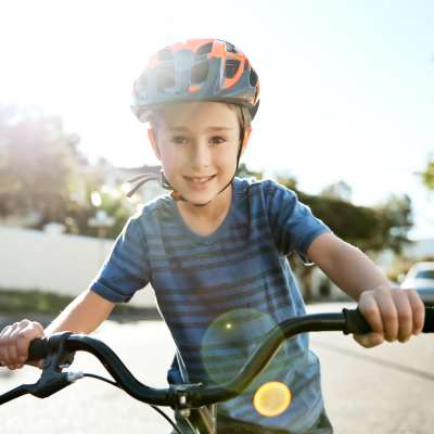 A kid learning to ride his bike on the road near Century Deerwood Park, Jacksonville, Florida