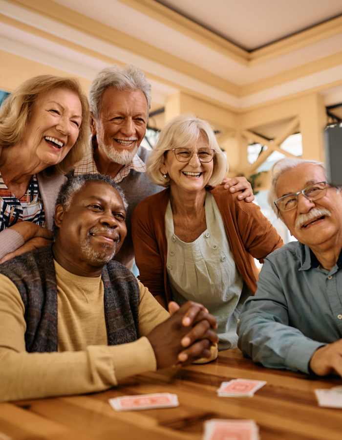 residents playing cards and taking a selfie at Clearwater at The Arboretum in Austin, Texas