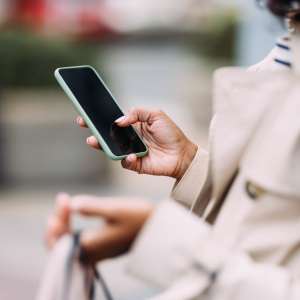 Resident using her mobile at Anchor Apartments in Freeport, Florida, 