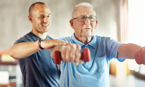 Caretaker assisting a resident for physical therapy at The Blake at Charlottesville in Charlottesville, Virginia