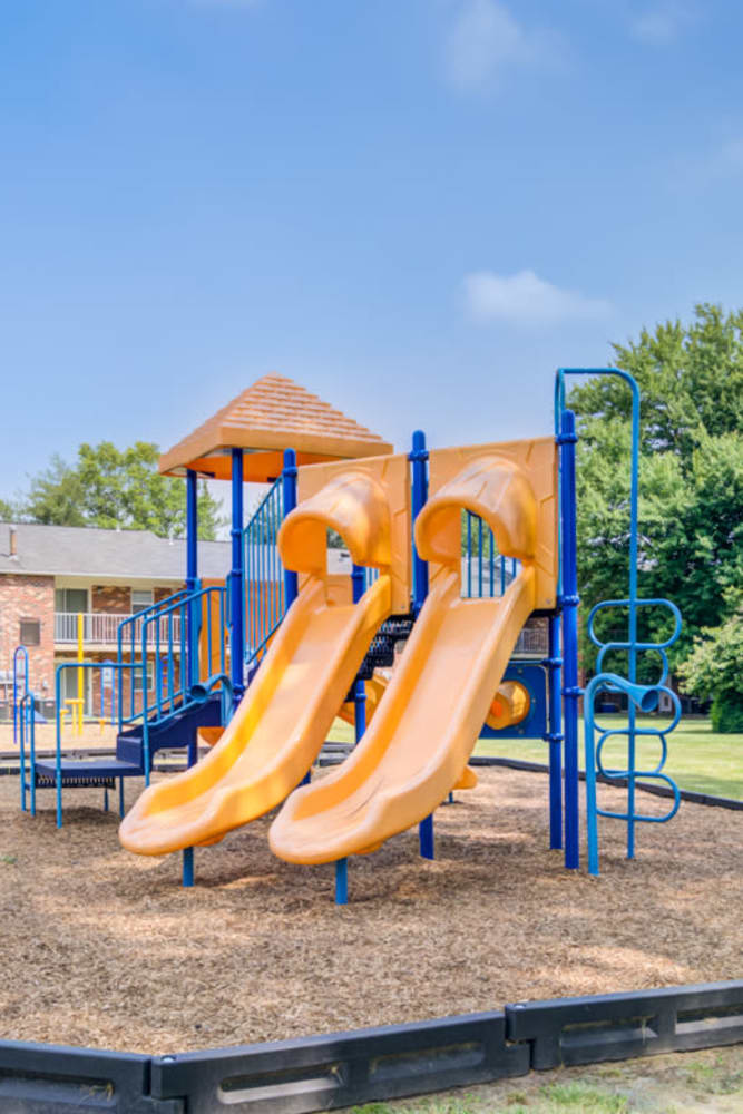 Orange and blue playground with 2 slides at Mapleton Square Apartment Homes in Dover, Delaware