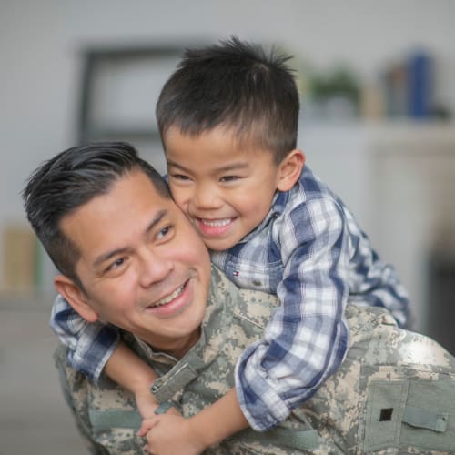 A military father and his son in a home at Gateway Village in San Diego, California