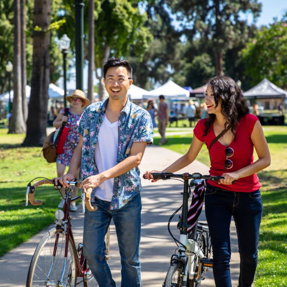 Resident walking in a park near Norwalk Towers Apartments in Norwalk, California