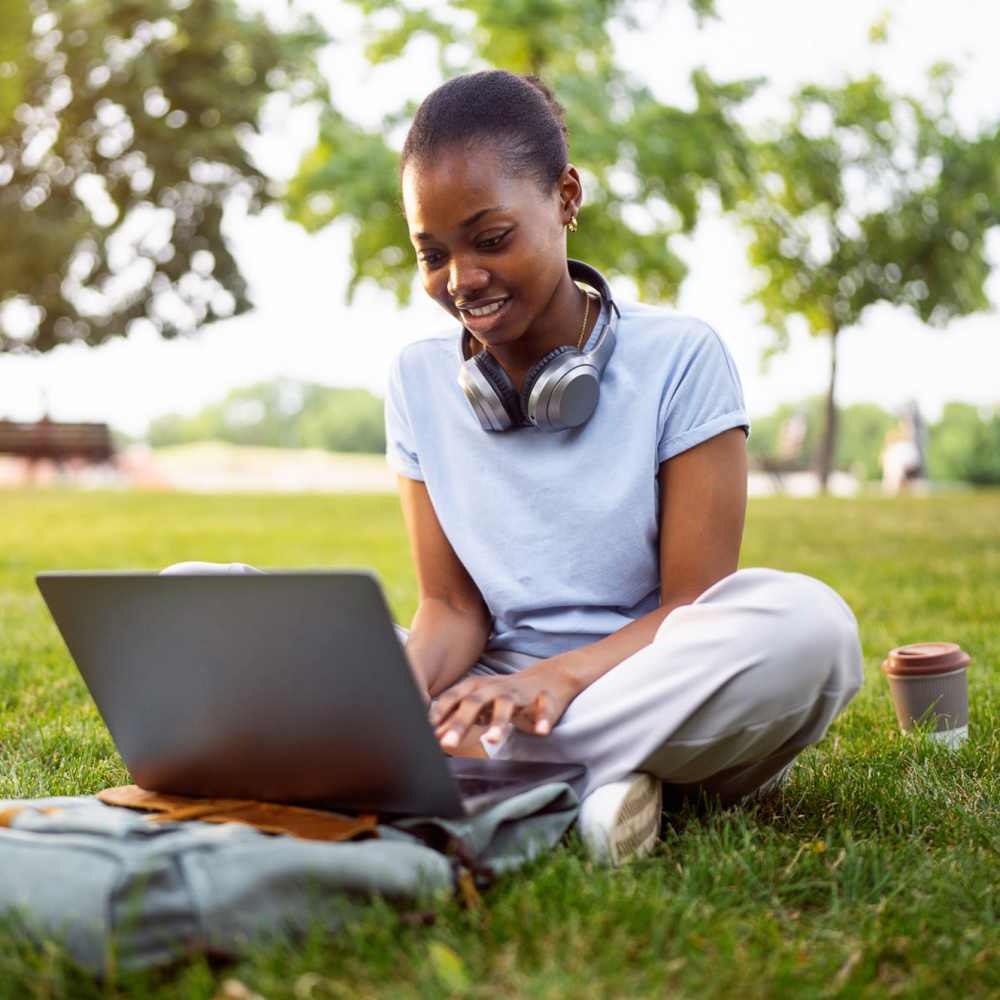 Woman working on laptop in park near Bayview Student Living in North Miami, Florida 