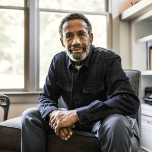 Resident sitting on a chair in his apartment at The Spring at Silverton in Fort Worth, Texas