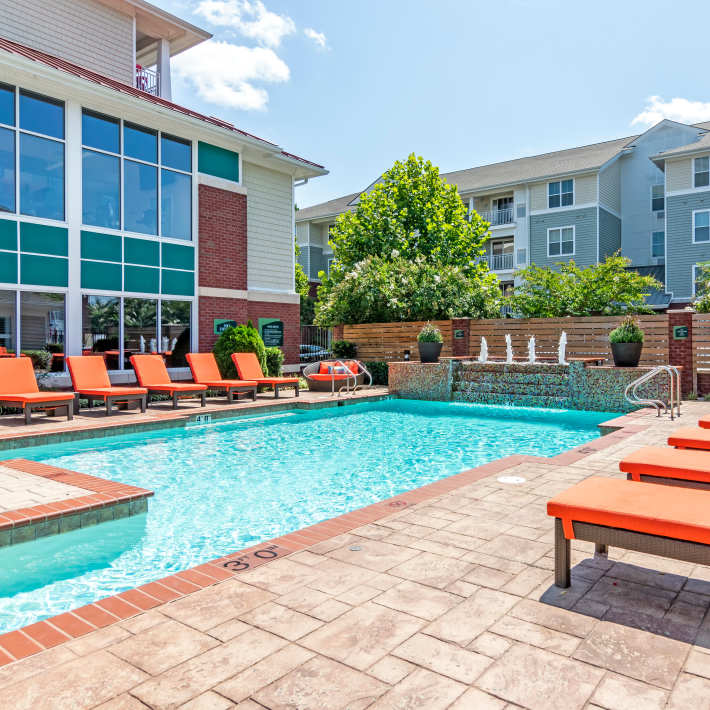 Resort-style pool with lounge chairs at The Carlton at Greenbrier, Chesapeake, Virginia