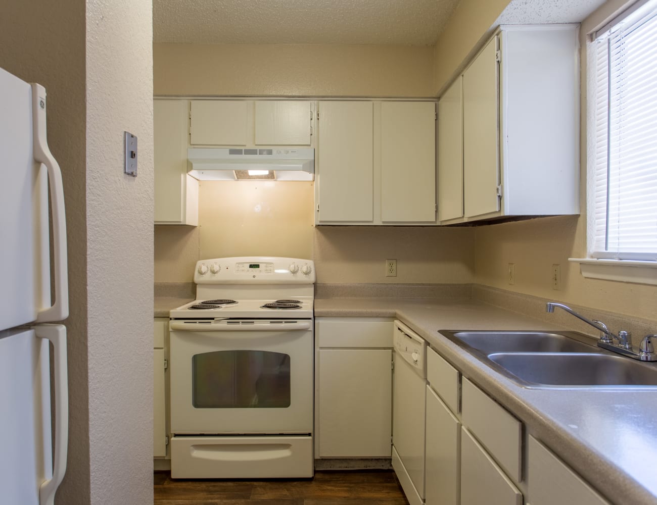 Spacious kitchen with hardwood floors at Canopy on Central in Bedford, Texas