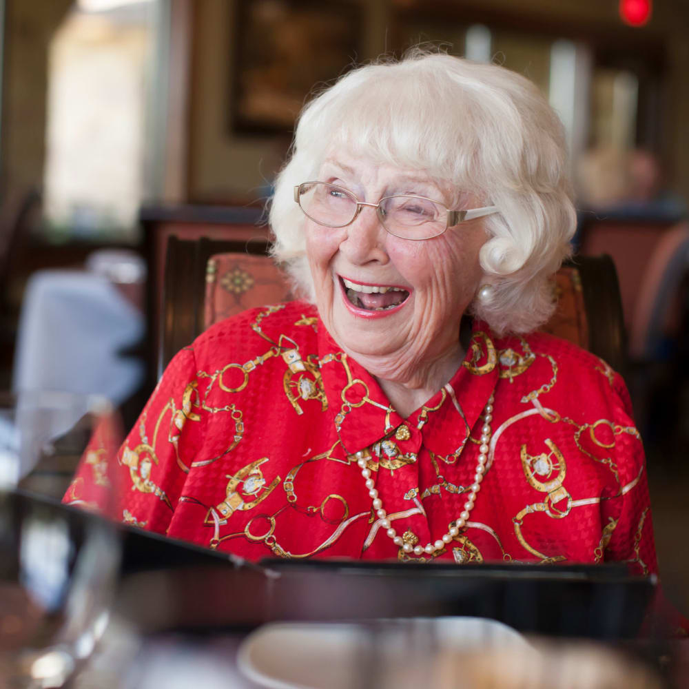 A laughing resident at Chateau Gardens Memory Care in Springfield, Oregon