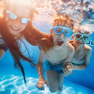 Kids underwater in a swimming pool at San Onofre I in San Clemente, California