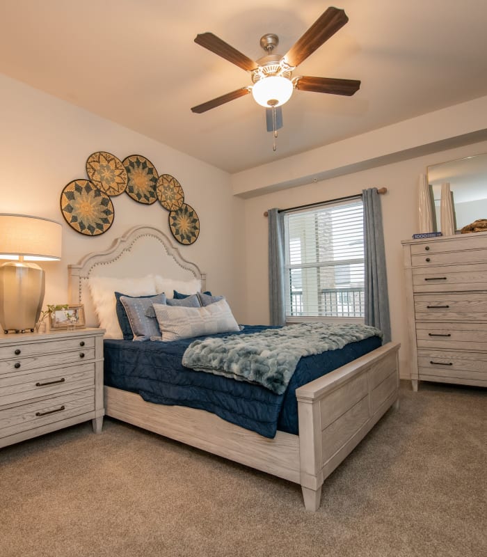 Chic bedroom with ceiling fan at Redbud Ranch Apartments in Broken Arrow, Oklahoma