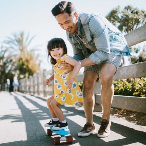 A resident helping his daughter skateboard at San Onofre I in San Clemente, California