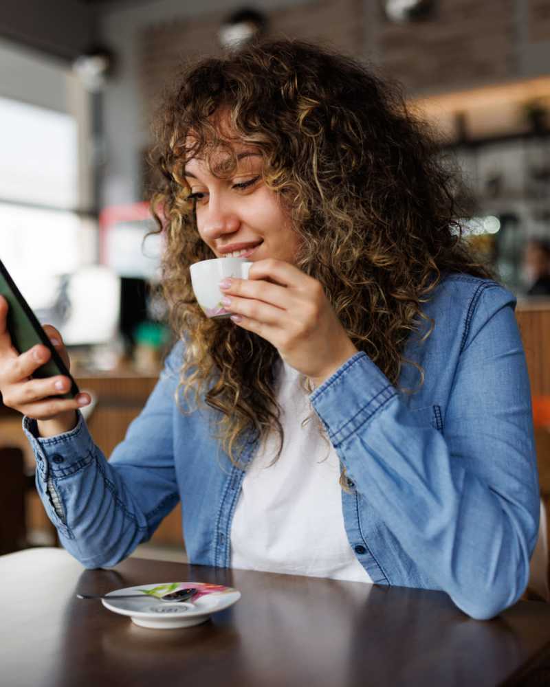 Resident having coffee at a cafe nearby Vivo Living Charlotte in Charlotte, North Carolina