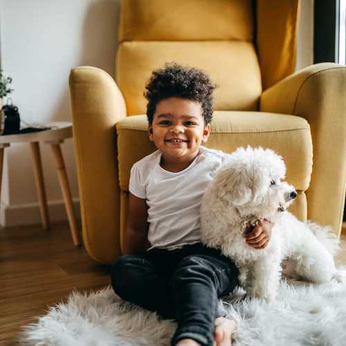 Dog sitting next to a child in an apartment at Copper Steppe in Parker, Colorado