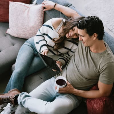 Couple relaxing at resident clubhouse at Pacific View in Oceanside, California