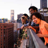 residents looking out from terrace at The Reed in Pittsburgh, Pennsylvania