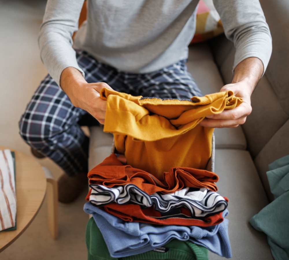 Resident putting clothes in laundry at Polly O'Meara Doyle Hall in Santa Rosa, California