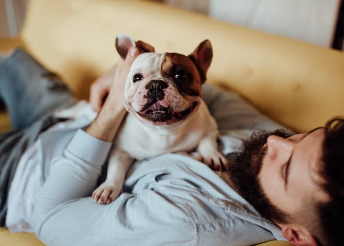 Resident laying down with his cute dog at Casanova Monterey in Monterey, California