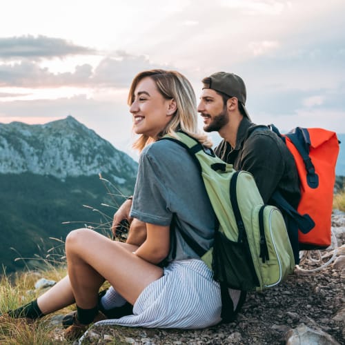 Two people rest to take in the mountain views on a hike near M2 Apartments in Denver, Colorado