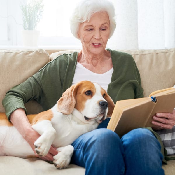 A resident reads to her dog at Chesapeake Place Senior Living in Chesapeake, Virginia.