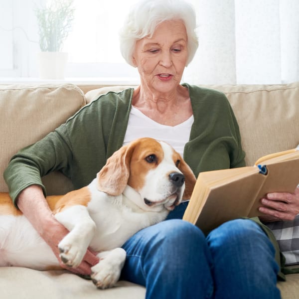 A resident reading to her dog at Sellwood Senior Living in Portland, Oregon. 