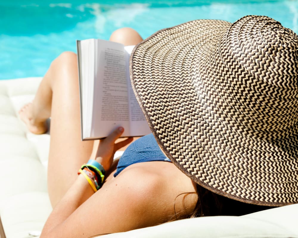 Residents reading a book by the pool at The Edison in Sacramento, California
