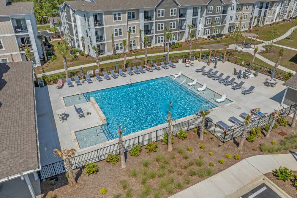 Residents enjoying resort-style swimming pool at The Edison at Farrow Commons in North Myrtle Beach, South Carolina