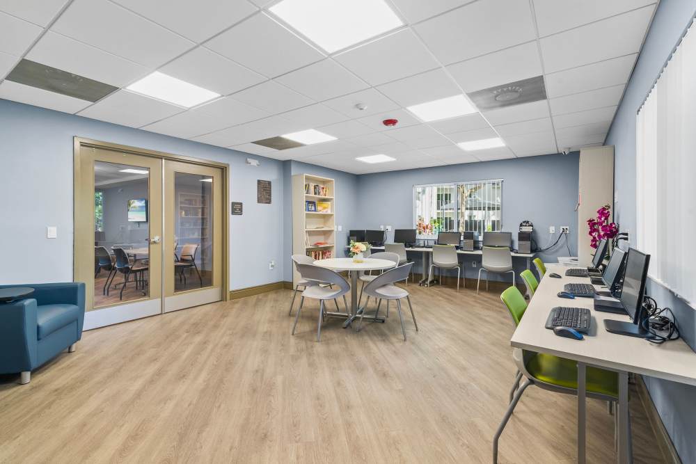 Community business center with multiple desktops at Sunset Bay Apartments in Cutler Bay, Florida