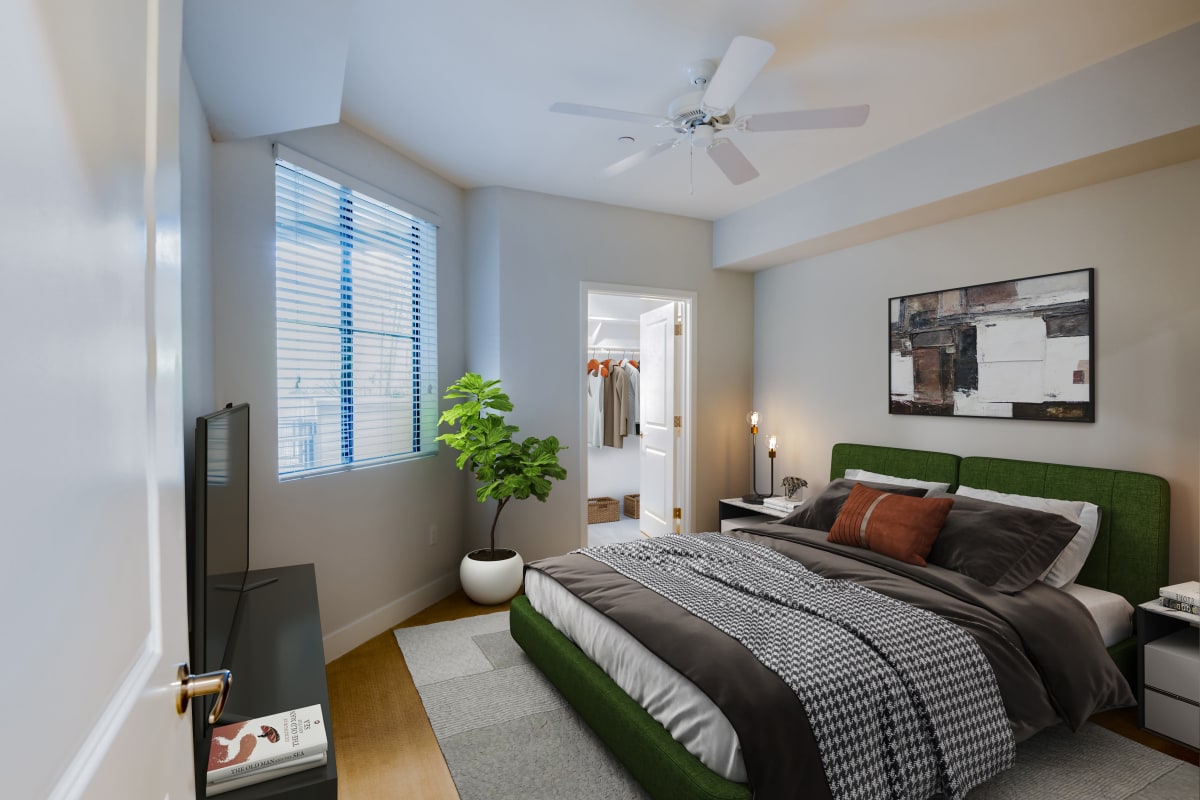 A bedroom with a walk-in closet at The Aubrey in Tempe, Arizona