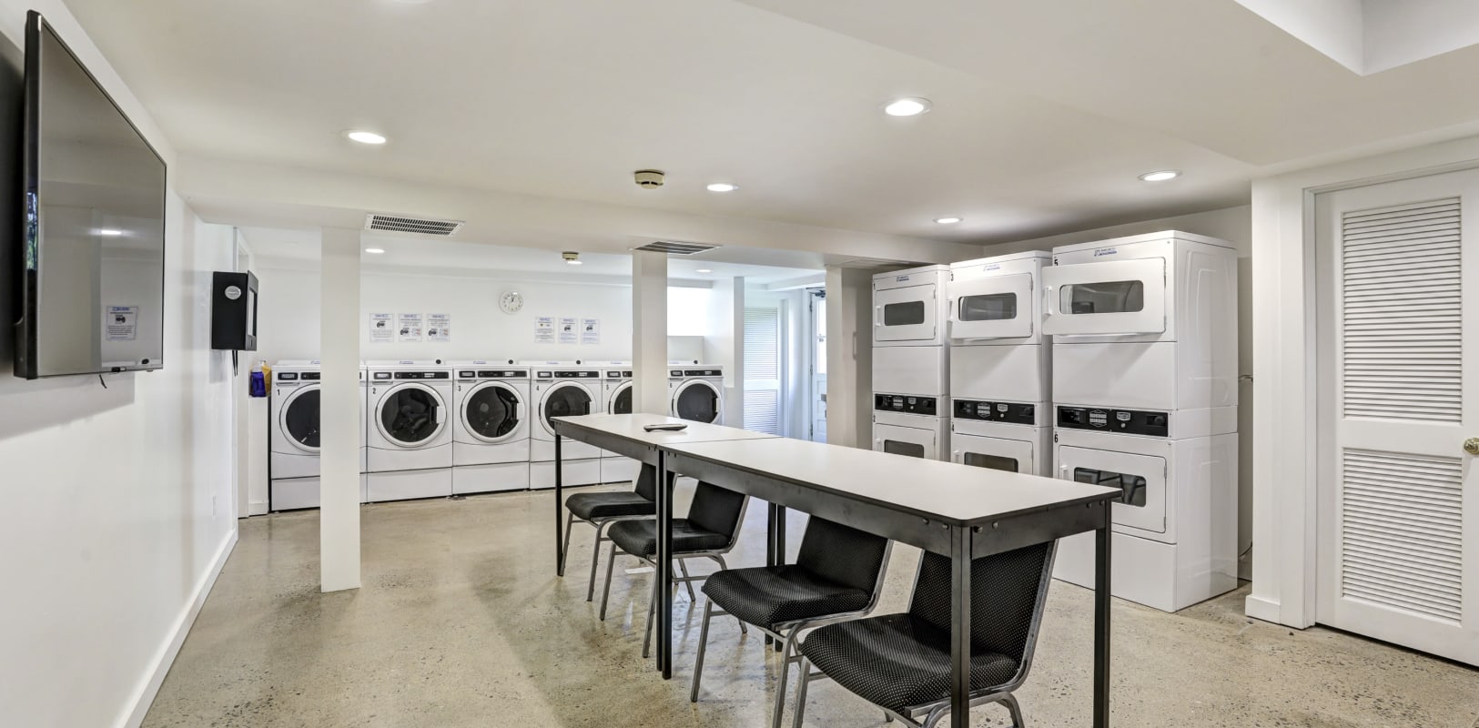 Community laundry room with plenty of machines at General Wayne Townhomes and Ridgedale Gardens in Madison, New Jersey