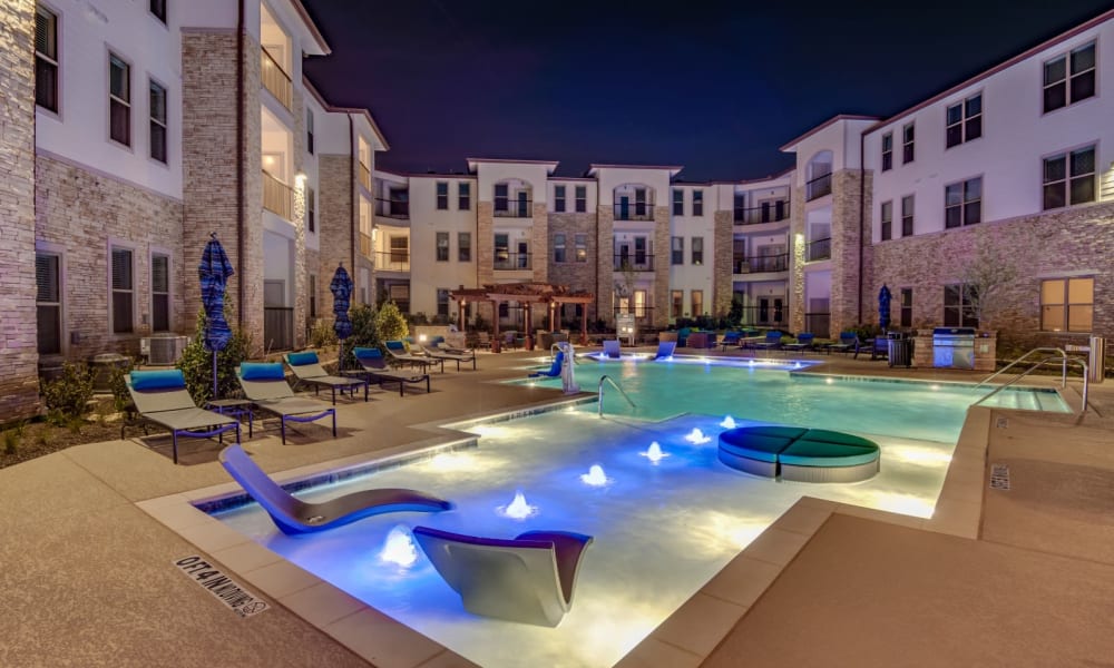 Awesome pool at night with lights in the water at Bellrock Upper North in Haltom City, Texas