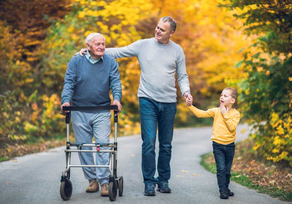 Resident with son and grandson walking outside near Clearwater at The Arboretum in Austin, Texas