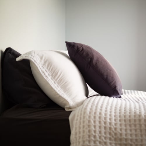 A cozy bed in an apartment at Vesta Creeks Run in North Charleston, South Carolina