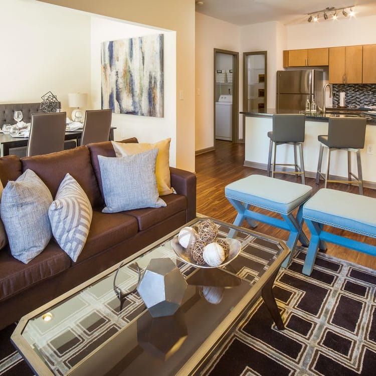 Well-decorated living area with hardwood floors in model home at Presley Oaks in Charlotte, North Carolina