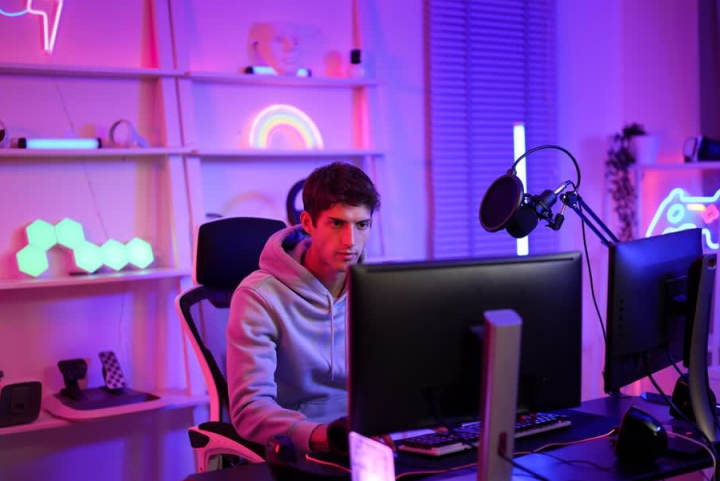 Man playing in game room, which is organized by leaning shelves