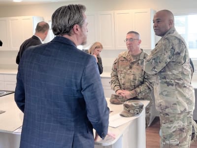 Lt. Gen. Kevin Vereen, right, deputy chief of staff, Army G-9, gets a briefing along with a walk-through tour with of one of the base houses during his visit to Joint Base Lewis-McChord April 3. Pictured left, Kevin Clarke, Senior Vice President of Construction and Environmental Services.