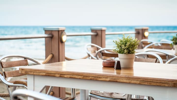 Breakfast tables overlooking the beach at Cape House Apartments in Jacksonville, Florida