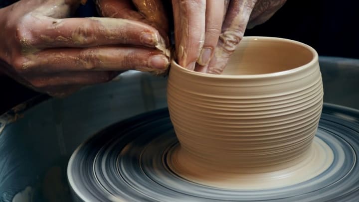 Potter working with clay at Odyssey Lake in Brunswick, Georgia