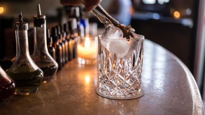 Bartender adding ice to glass at Richland Rum near Odyssey Lake in Brunswick, Georgia