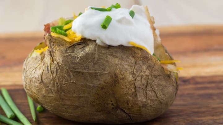 Stuffed baked potato with all the trimmings from a restaurant near Lux on Main in Carrollton, Texas