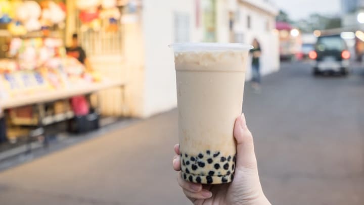 Plastic cup of boba tea near Lux on Main in Carrolton, Texas