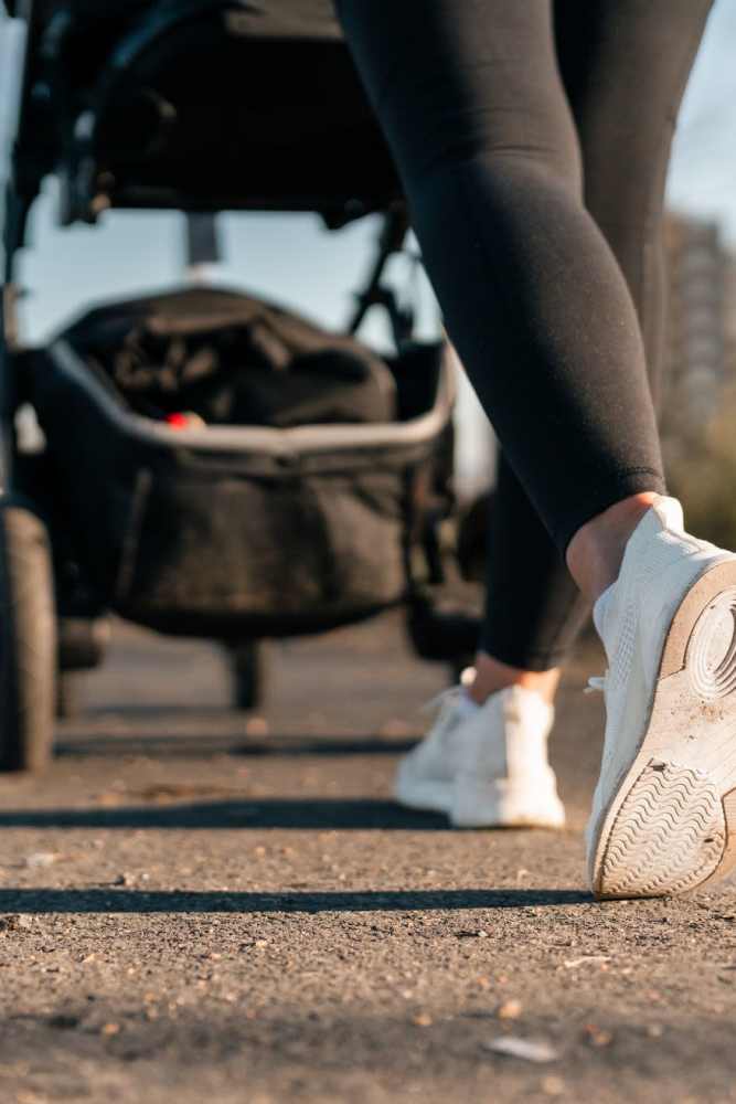 Resident walking with a stroller near Sunrise Meadows Apartments in Rancho Cordova, California