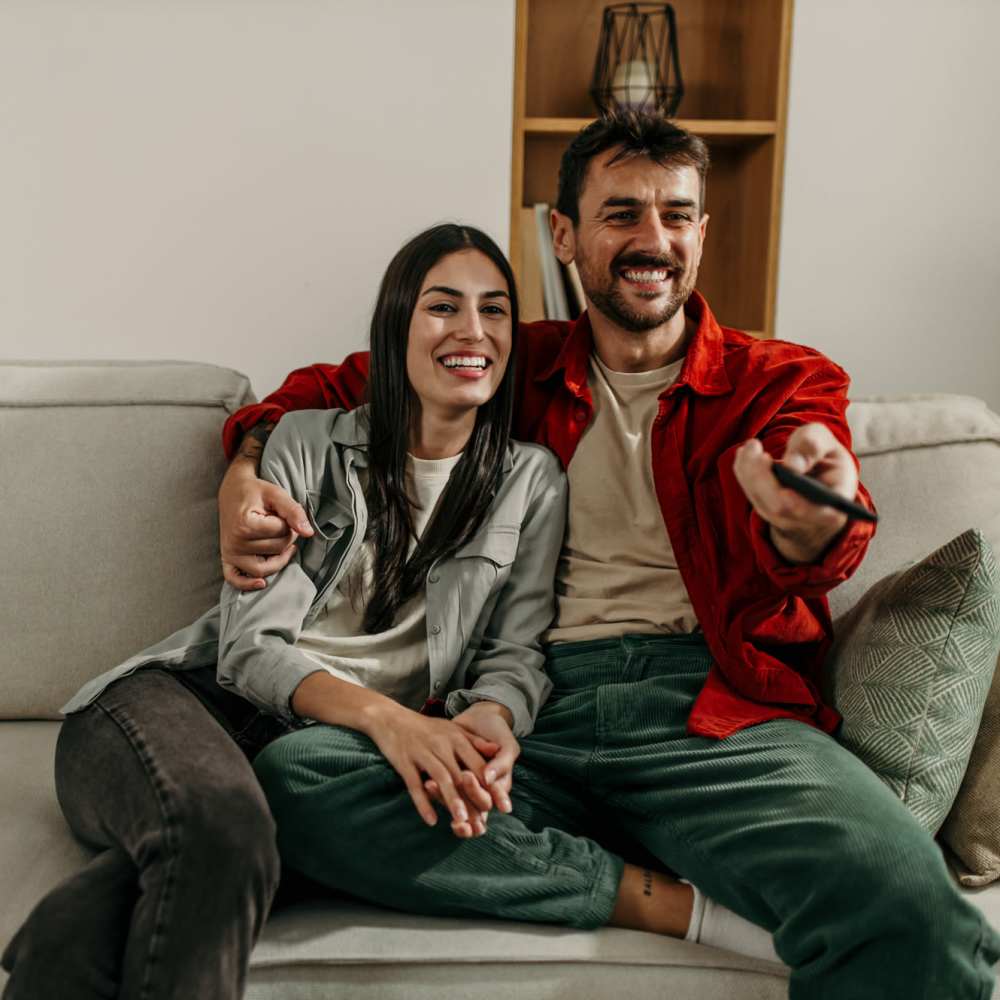 Couple having good time in their cozy living room at Ansley Murrayhill in Tigard, Oregon